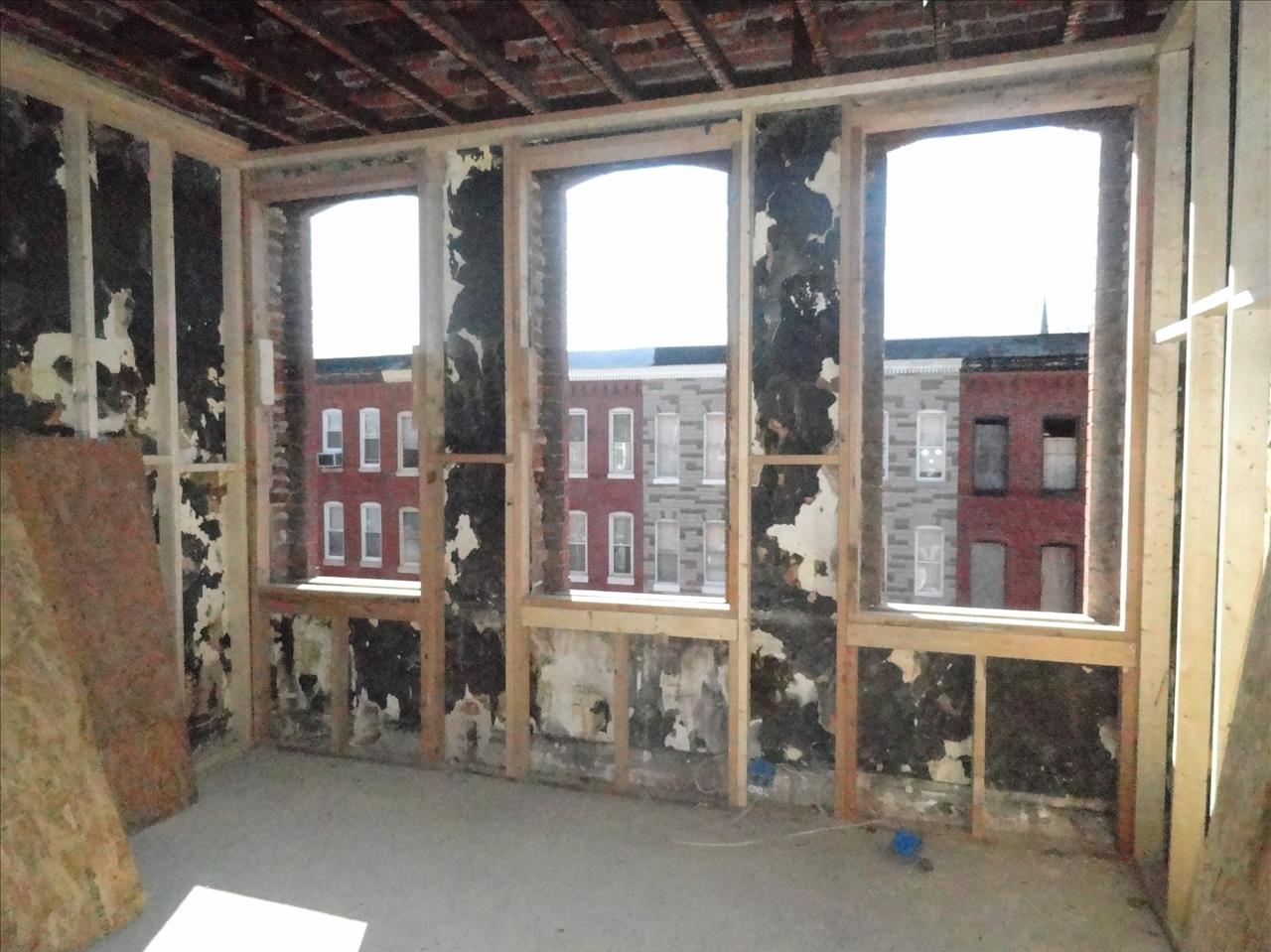 426 Mosher Street interior before renovation. Shell townhome with no windows.