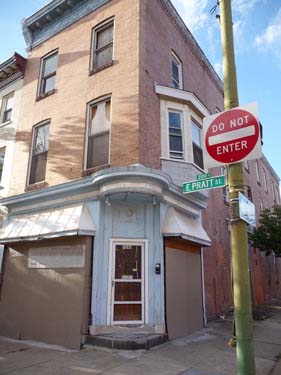 2040 E. Pratt Street before renovation. Baltimore City rowhome with boarded windows.
