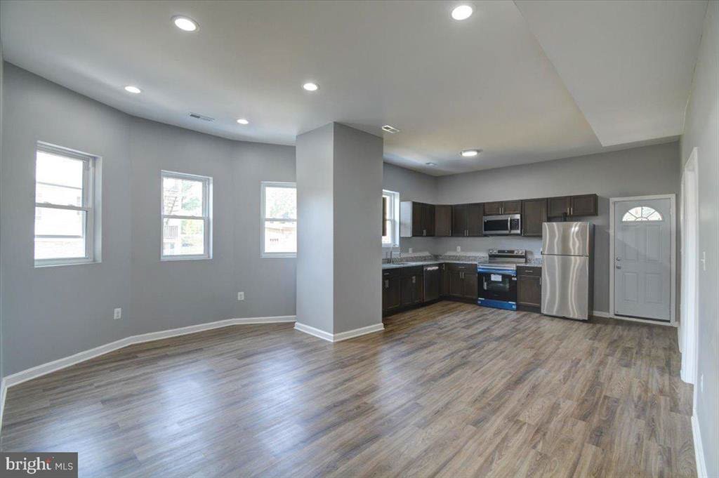 2125 Denison Street after renovation. Open space with new kitchen and gray walls.