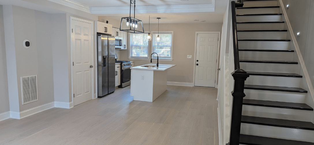 2928 Oakford Avenue after renovation. Black and white staircase with aisle lighting.